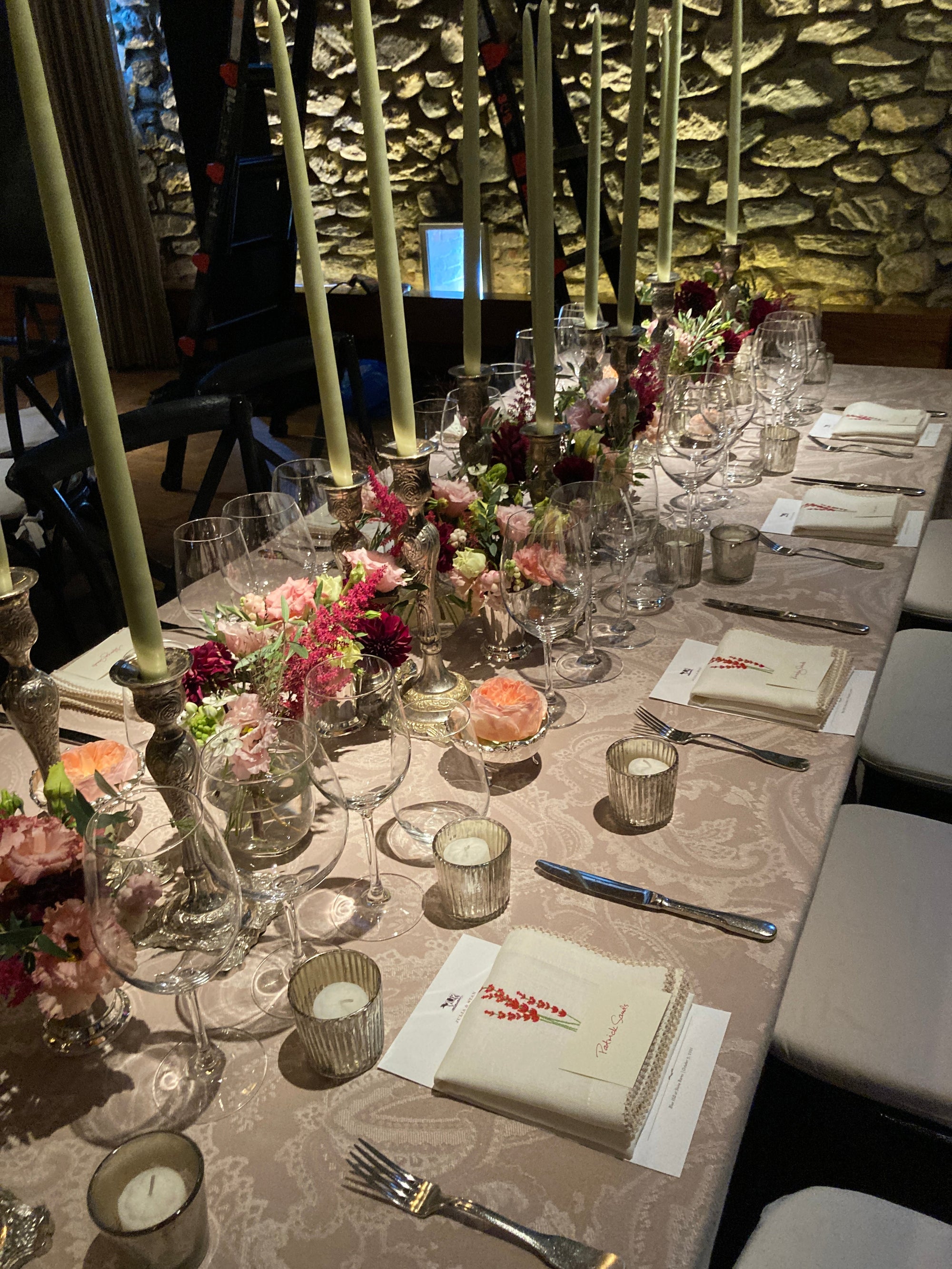 Bud vases and candles set along a long dining table