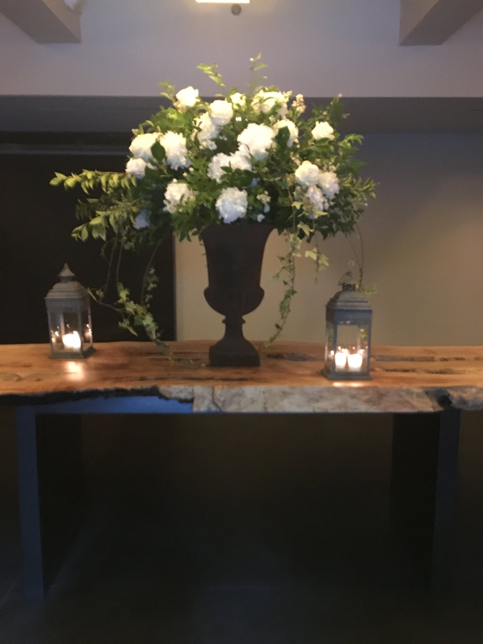 White urn arrangement on a quiet entry table