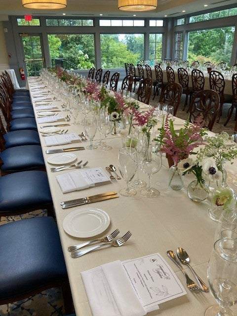 Garden table arrangement showing repurposed ceremony flowers at a Westchester estate wedding