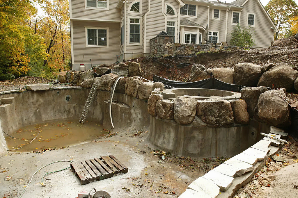 Mid-construction pool installation showing phased work