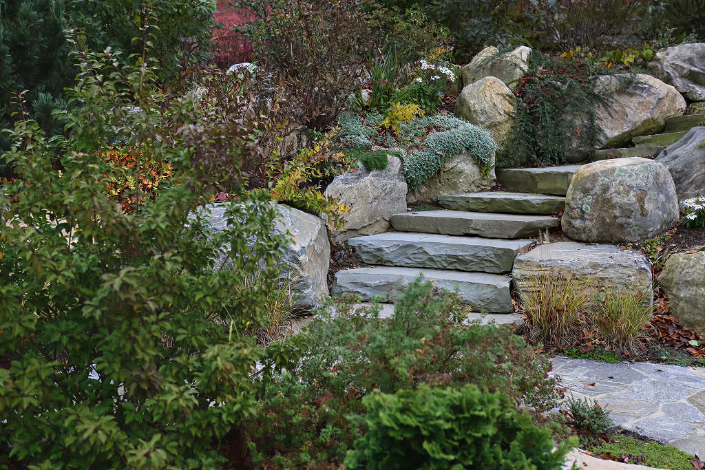 Rustic autumn rock garden with natural stone — representative of Waccabuc project work